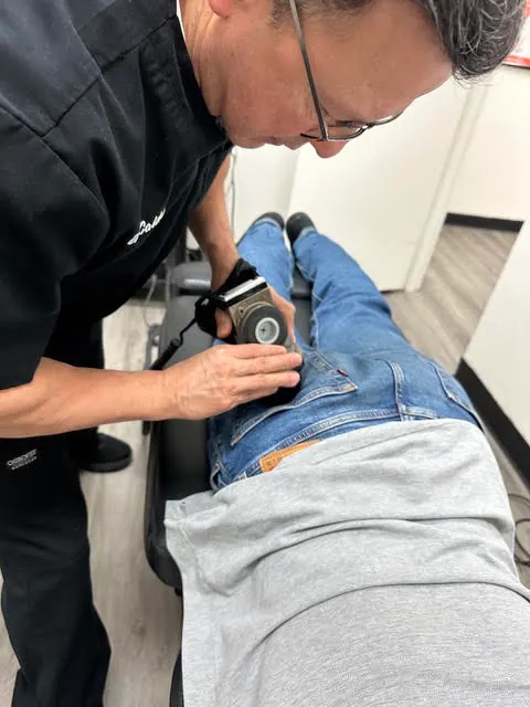 Dr. Caldero treating a patient’s lower back at Caldero Chiropractic in Arcadia